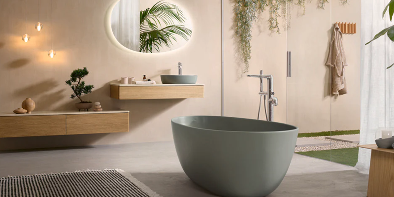 Sage green matt bath in organic bathroom with timber and nickel